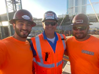three construction workers posing for a selfie